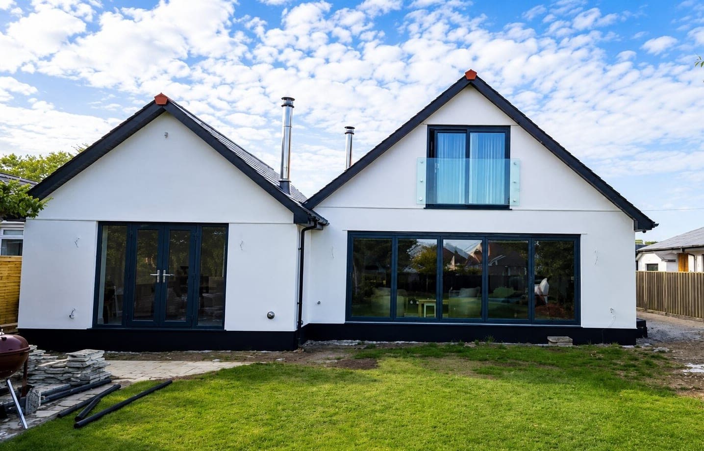 Completed rendered new build home with anthracite windows and bifold doors in Cornwall