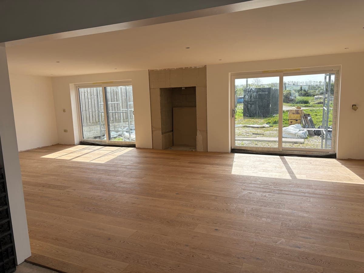 Open-plan kitchen extension with sliding doors and oak flooring in Cornwall