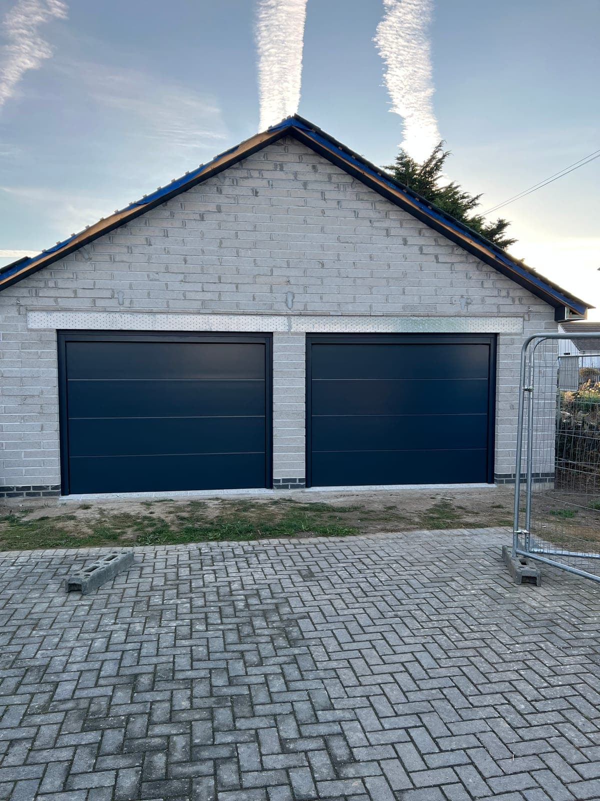 New build home under construction with rendered blockwork and anthracite windows
